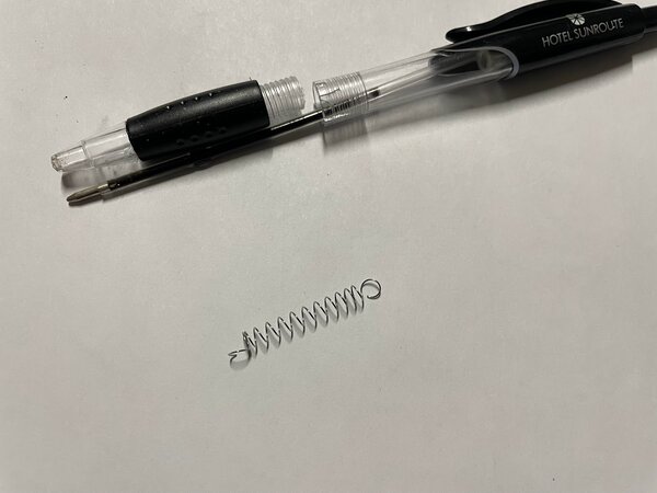 Bend the pen spring like this